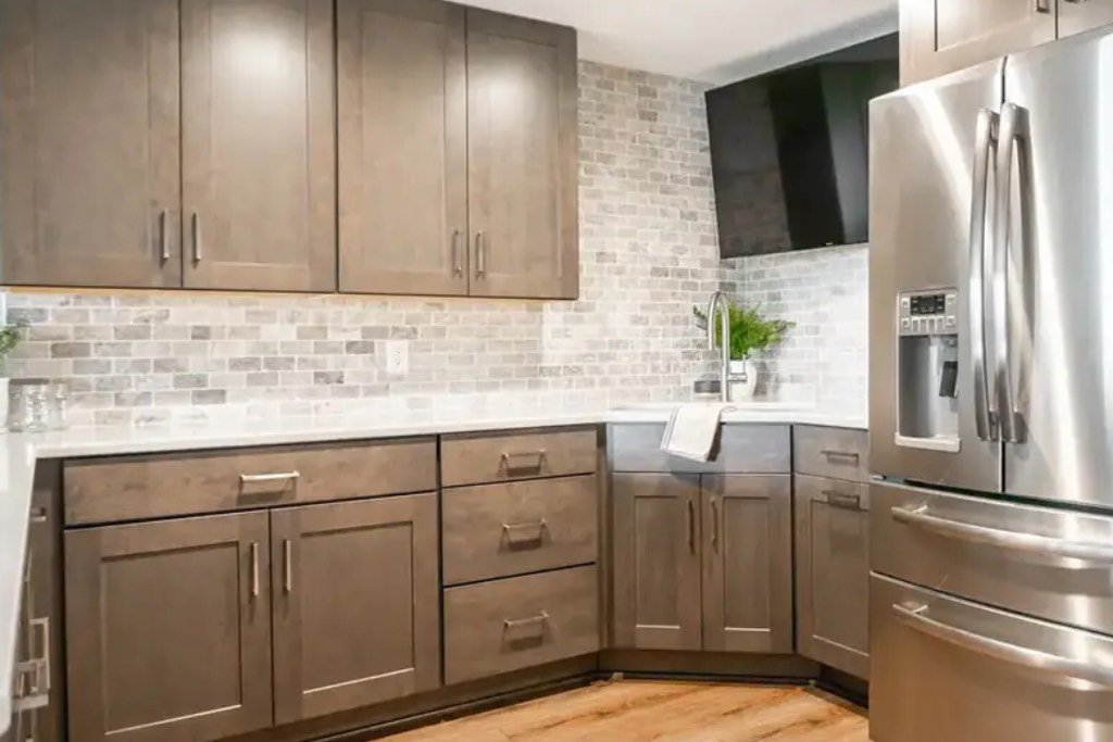 Expert applying paint to kitchen cabinet doors