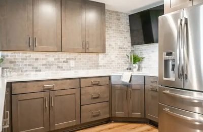 Expert applying paint to kitchen cabinet doors